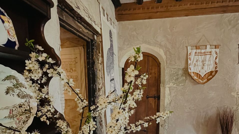 Flowers on a wooden dresser in the Great Hall