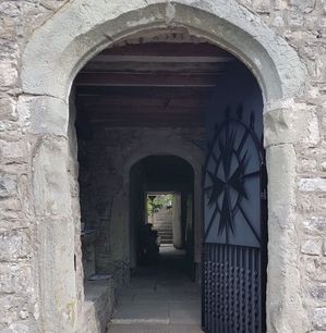Arched front door opening into the passageway to the house